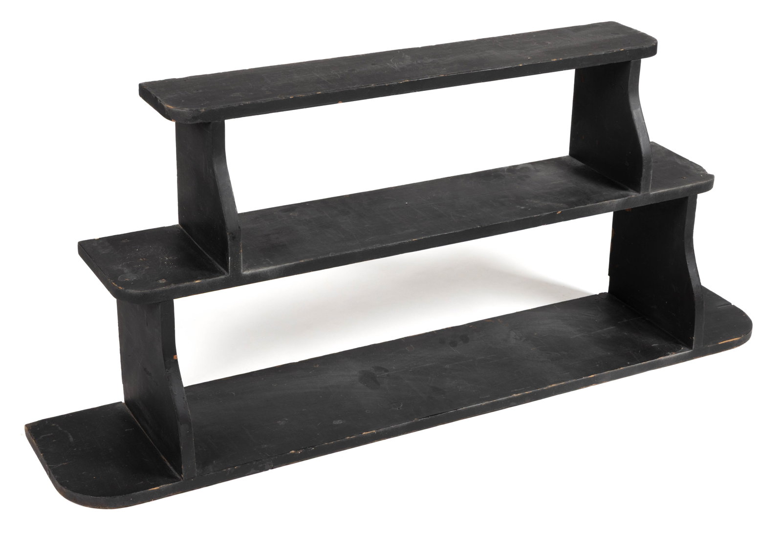 AMERICAN PAINTED HANGING WALL SHELF: AMERICAN PAINTED HANGING WALL SHELF, pine or poplar, having three rectangular single-board shelves with rounded front corners supported by shaped brackets. Retains an old black-painted surface. First