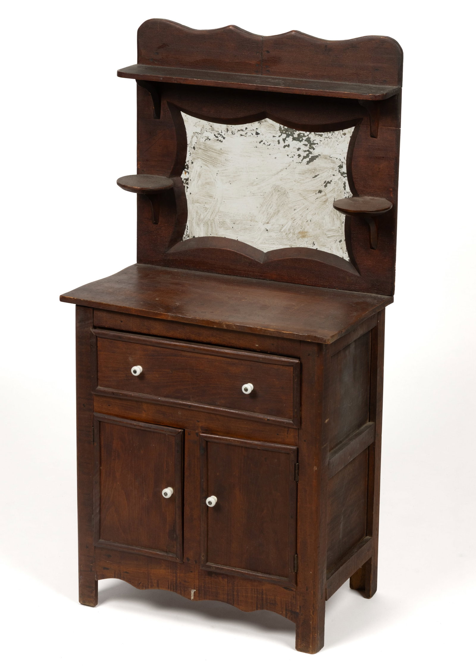 AMERICAN VICTORIAN MAPLE CHILD'S DRESSER: AMERICAN VICTORIAN MAPLE CHILD'S DRESSER, maple stained to appear as walnut, featuring a rectangular back with a shaped crest, shallow shelf, and rectangular mirror with a shaped edge flanked by