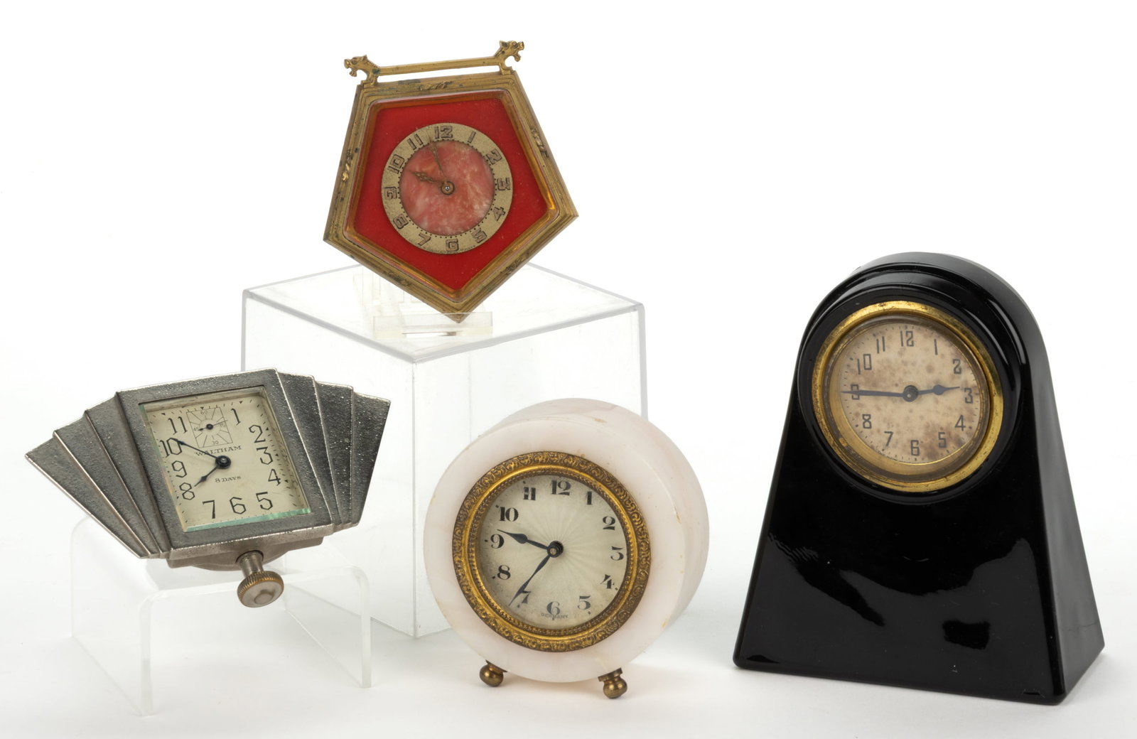 ASSORTED ART DECO TABLE / DESK CLOCKS, LOT OF FOUR: ASSORTED ART DECO TABLE / DESK CLOCKS, LOT OF FOUR, companies including Waltham, New Haven, and Doxa, with nickel-plated, alabaster, deep cobalt (almost black) glass, and gilt metal cases. Glass examp