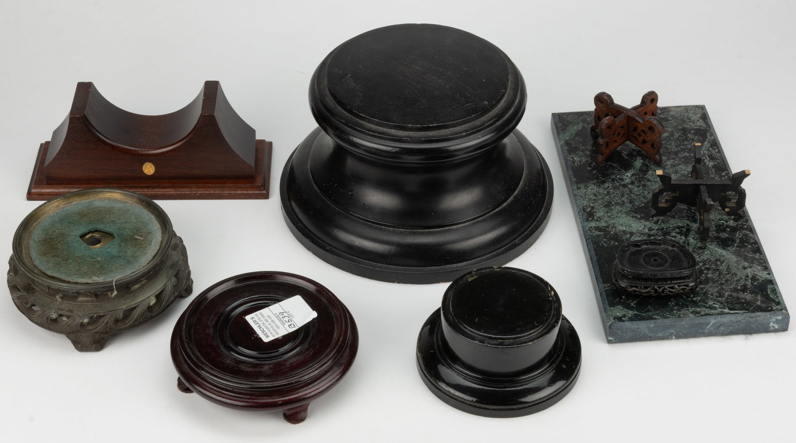 ASSORTED BASES AND TROPHY STANDS, LOT OF NINE: ASSORTED BASES AND TROPHY STANDS, LOT OF NINE, including several Asian or Asian-style examples, a slab of marble, and one metal lamp base. Largest turned example 5 1/2" HOA, 10" D. Provenanc