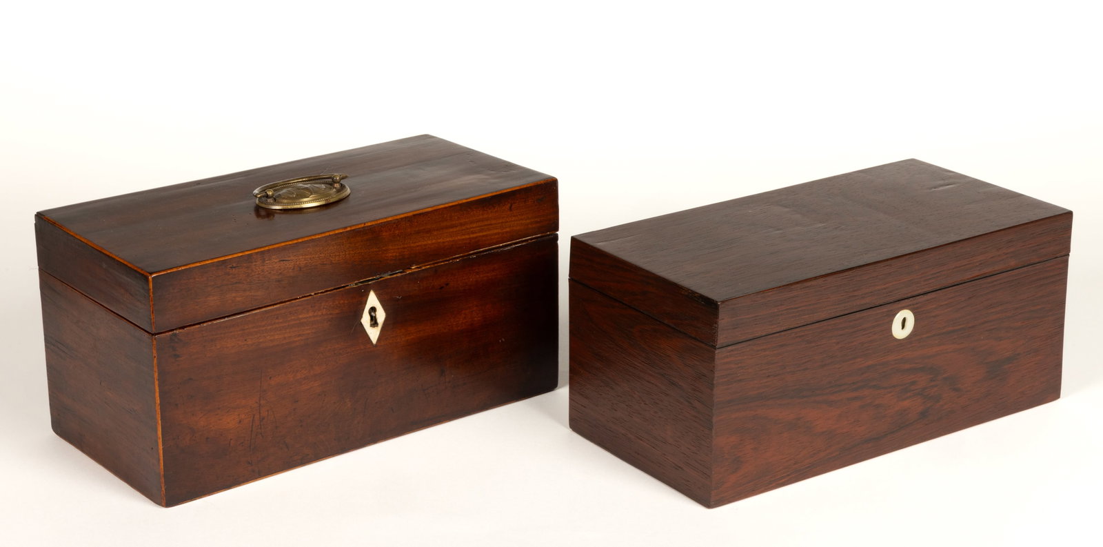 ASSORTED BRITISH WOODEN TEA CADDIES, LOT OF TWO: ASSORTED BRITISH WOODEN TEA CADDIES, LOT OF TWO, each of rectangular form with a hinged lid, comprising of a mahogany example with the lid having an oval-form backplate with drapery and an u