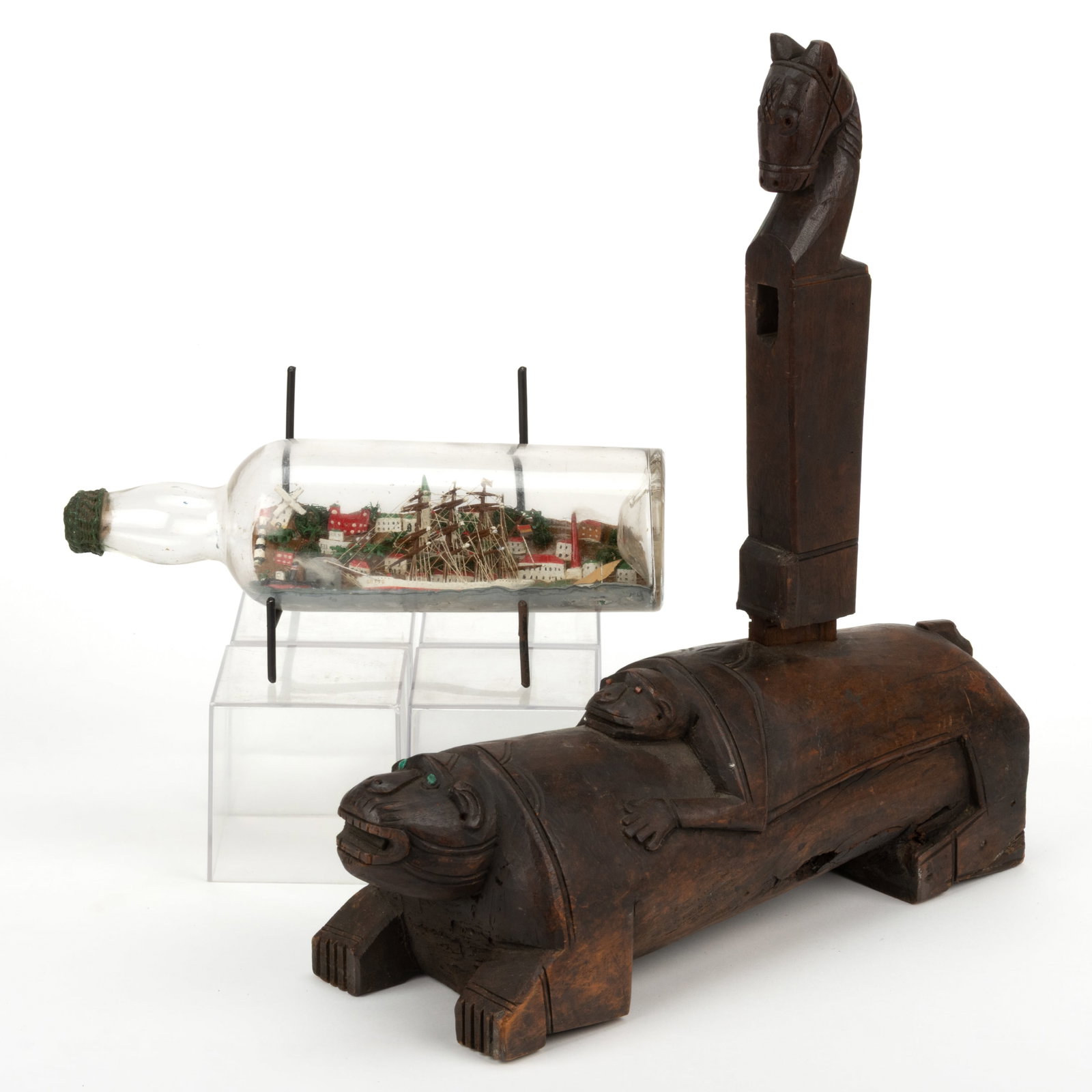 ASSORTED FOLK ART CARVED DECORATIVE ARTICLES, LOT OF TWO: ASSORTED FOLK ART CARVED DECORATIVE ARTICLES, LOT OF TWO, comprising a carved Asian or African object with two animal figures as the base and a mortised-in horse-topped extension on the top; and a shi