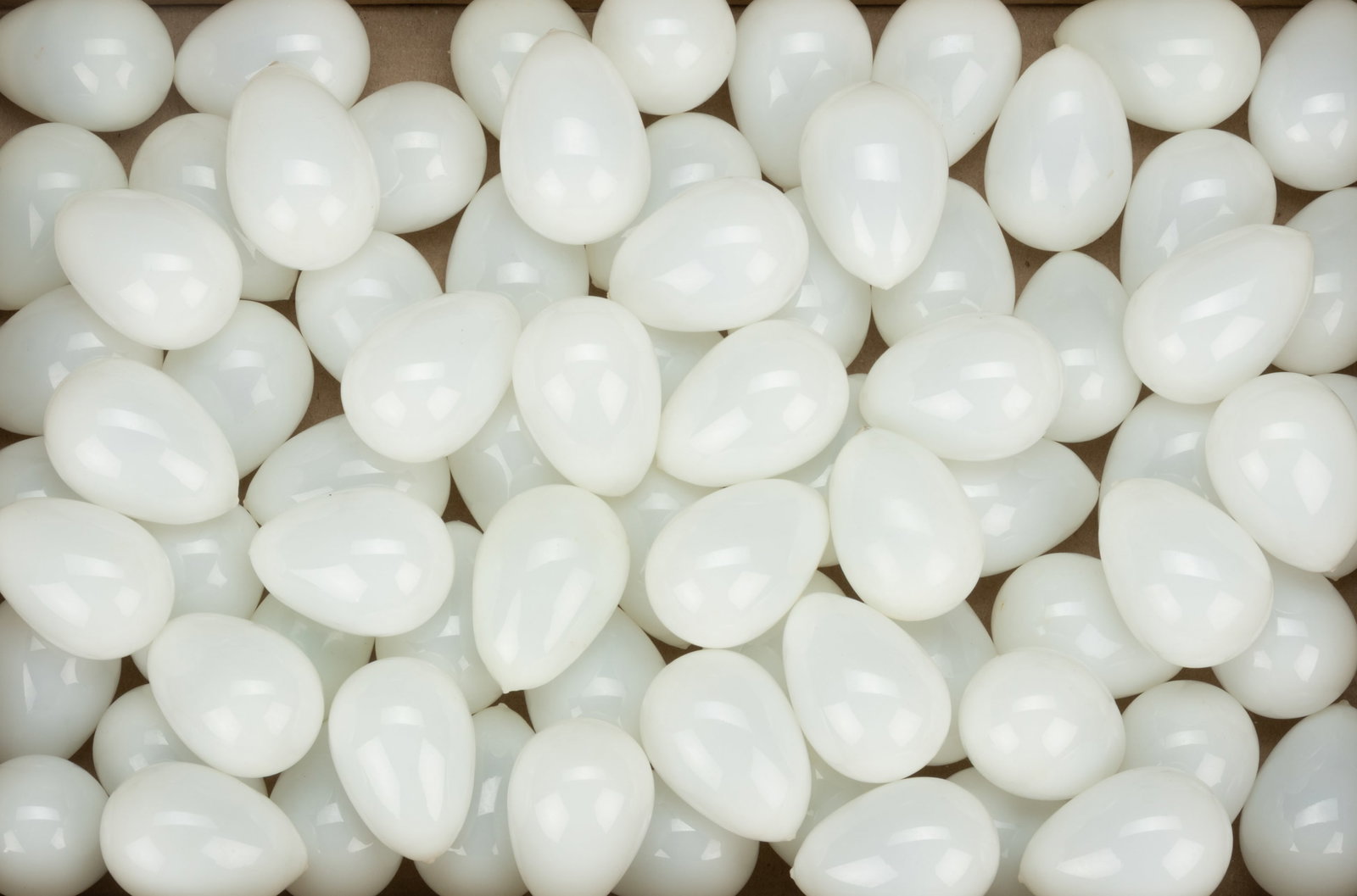BLOWN GLASS EGGS, LOT OF 76: BLOWN GLASS EGGS, LOT OF 75, opal, each being chicken-sized, each with a rough pontil mark. 19th century. Approximately 2 1/2" to 2 5/8" LOA.