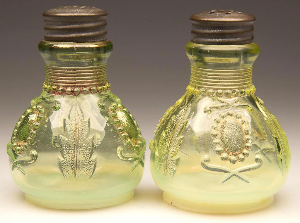JEWEL AND FLOWER / ENCORE PAIR OF SALT AND PEPPER SHAKE: JEWEL AND FLOWER / ENCORE PAIR OF SALT AND PEPPER SHAKERS, vaseline (uranium) opalescent with traces of gilt decoration, matching period lids. Northwood Glass Co. Early 20th century. 3 1/8" HOA. Liter