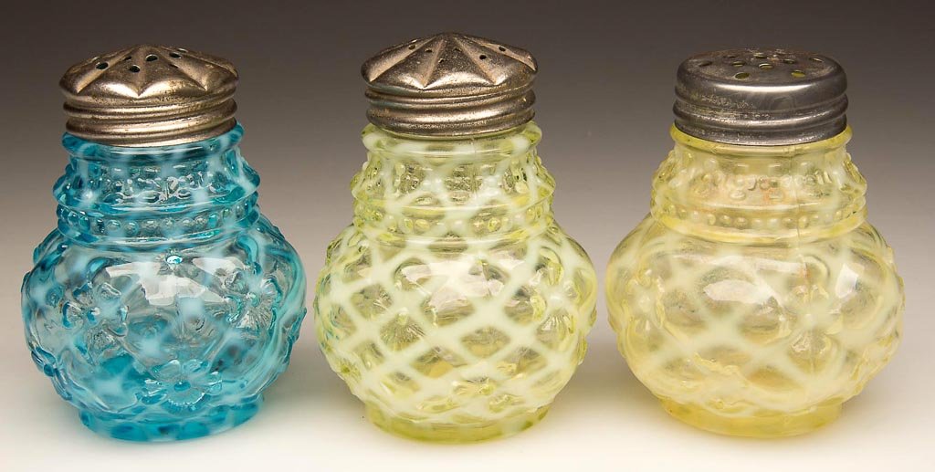 QUILTED PHLOX SALT SHAKERS, LOT OF THREE: QUILTED PHLOX SALT SHAKERS, LOT OF THREE, comprising two vaseline (uranium) and a blue opalescent, period lids including a matching pair. Northwood Glass Co. Late 19th/early 20th century. 3 1/2" HOA. 