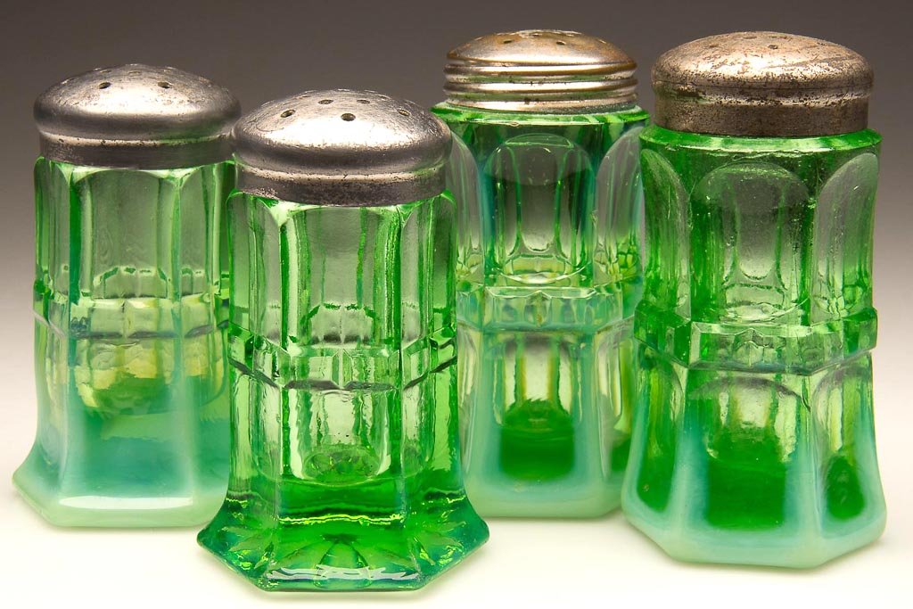 REGAL - NORTHWOOD'S TWO PAIR SALT AND PEPPER SHAKERS: REGAL - NORTHWOOD'S TWO PAIR SALT AND PEPPER SHAKERS, green opalescent, comprising a short pair with large 12-point star under base and a tall pair with small 24-point sunburst under base, period lids