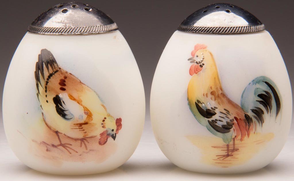 PAIRPOINT EGG - FLAT-END PAIR OF SALT AND PEPPER SHAKER: PAIRPOINT EGG - FLAT-END PAIR OF SALT AND PEPPER SHAKERS, opaque white, with plush/satin finish, with polychrome hen and rooster decorations and matching period lids. Attributed to Pairpoint Glass Co.