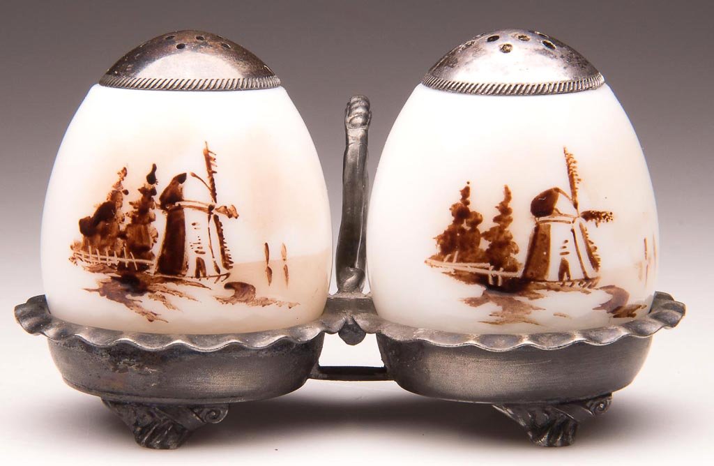 PAIRPOINT DELFT EGGS - FLAT-END PAIR OF SALT AND PEPPER: PAIRPOINT DELFT EGGS - FLAT-END PAIR OF SALT AND PEPPER SHAKERS, opaque white with glossy finish, each shaker with sepia windmill decoration. Fitted in a quadruple-plate stand marked "PAIRPOINT MFG CO