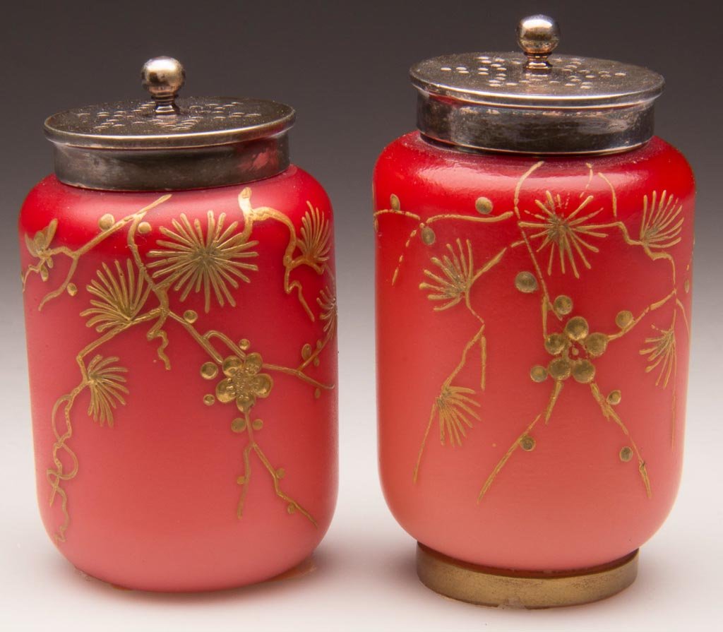WEBB PEACH BLOW SALT AND PEPPER SHAKERS: WEBB PEACH BLOW SALT AND PEPPER SHAKERS, gilt floral and butterfly decoration, with matching, period two-part lids. One on a gilt decorated foot. Thomas Webb & Sons. Fourth quarter 19th century. 2 3/8
