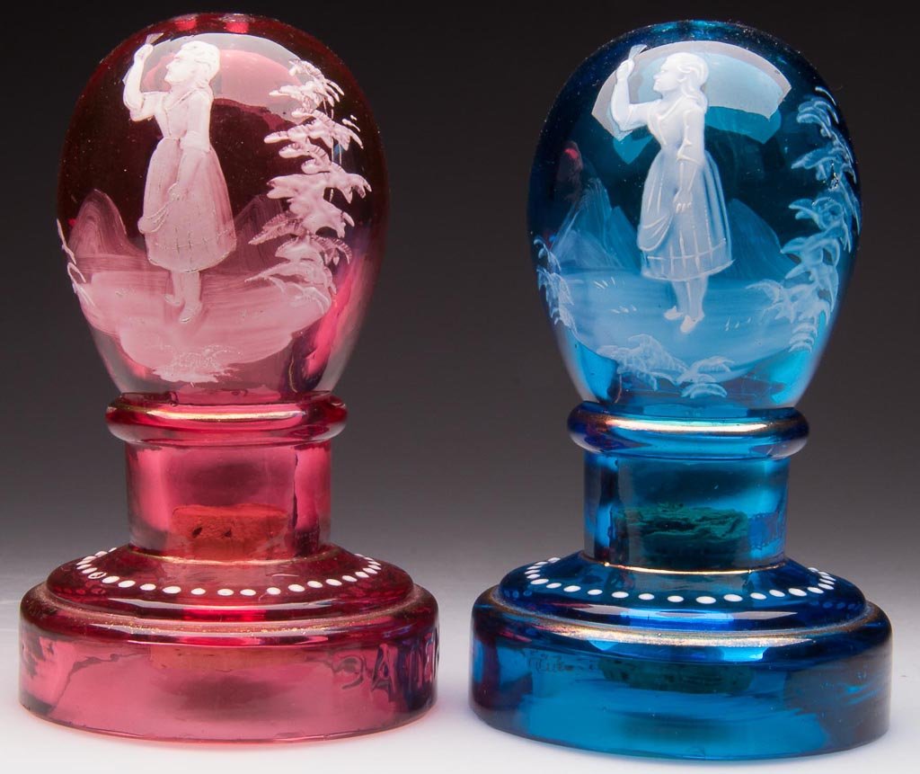 EGG ON PEDESTAL SALT AND PEPPER SHAKERS: EGG ON PEDESTAL SALT AND PEPPER SHAKERS, blue and cased cranberry, with gilding, each with Mary Gregory so called-like white enamel decoration. Embossed "PATENT" on base. Each base with factory polish