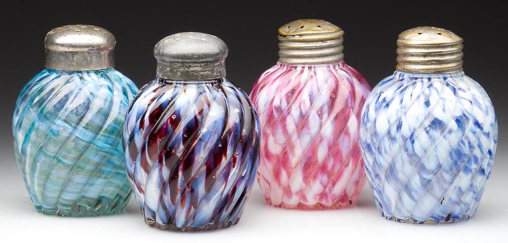 REVERSE SWIRL CASED SPATTER SALT SHAKERS, LOT OF FOUR: REVERSE SWIRL CASED SPATTER SALT SHAKERS, LOT OF FOUR, ball forms comprising blue and opal, cranberry and opal, green and opal, maroon and opal, period lids including a matching pair. Late 19th/early 