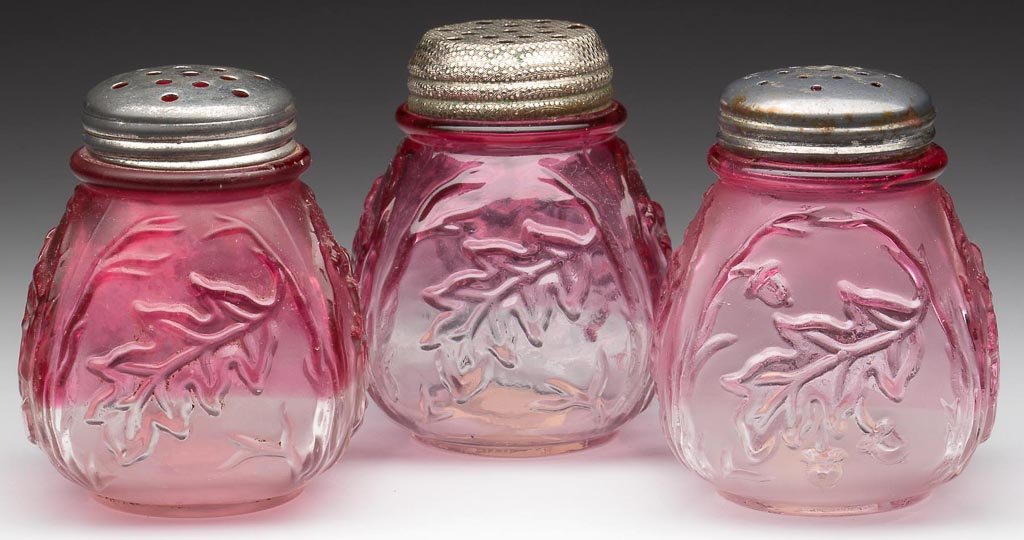 ROYAL OAK SALT SHAKERS, LOT OF THREE: ROYAL OAK SALT SHAKERS, LOT OF THREE, rubina, two with satin finish, period lids. Northwood Glass Co. Fourth quarter 19th century. 2 3/4" HOA. Provenance: The collection of the late Richard "Dick" and