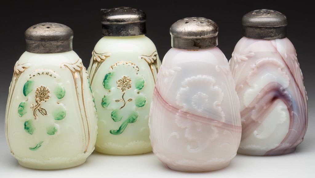 EVERGLADES / CARNELIAN SALT AND PEPPER SHAKERS, TWO PAI: EVERGLADES / CARNELIAN SALT AND PEPPER SHAKERS, TWO PAIR, comprising translucent purple slag and custard with green and gilt decoration, period lids. H. Northwood Co. Early 20th century. 3 1/4" HOA. P