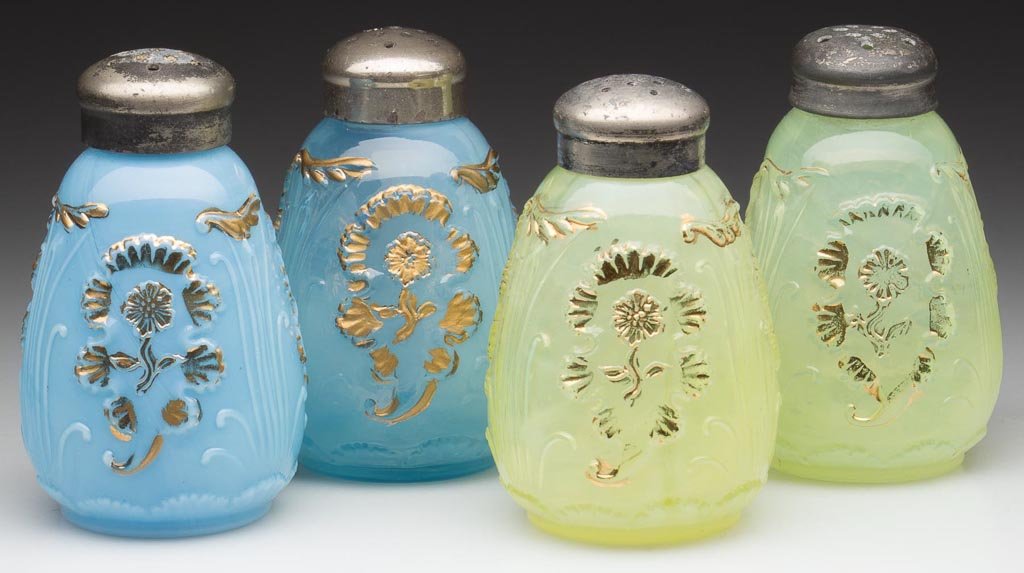 EVERGLADES / CARNELIAN SALT AND PEPPER SHAKERS, TWO PAI: EVERGLADES / CARNELIAN SALT AND PEPPER SHAKERS, TWO PAIR, comprising vaseline (uranium) opalescent and blue opalescent, each with gilt decoration, period lids. H. Northwood Co. Early 20th century. 3 1