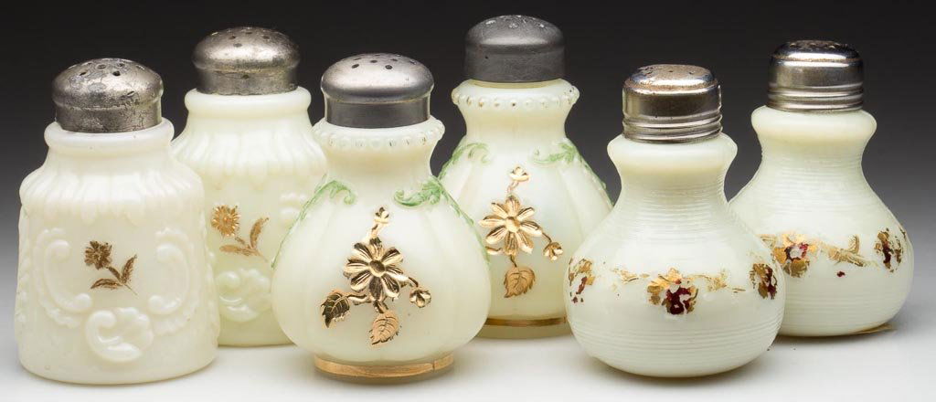 ASSORTED PATTERN SALT AND PEPPER SHAKERS, THREE PAIR: ASSORTED PATTERN SALT AND PEPPER SHAKERS, THREE PAIR, custard with gilt and enamel decorations, comprising Intaglio, Jackson and Louis XV, four with period lids. H. Northwood Co. Early 20th century. 3