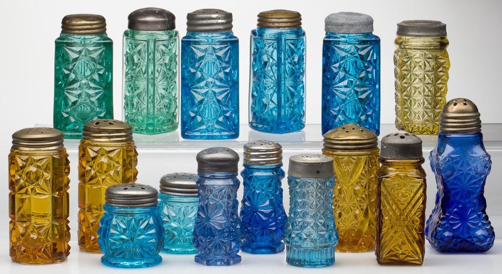 ASSORTED COLORED EAPG SALT AND PEPPER SHAKERS, LOT OF 1: ASSORTED COLORED EAPG SALT AND PEPPER SHAKERS, LOT OF 16, amber, apple green and differing shades of blue, pairs and singles, including Triangle and Star and Bar, period lids. Fourth quarter 19th cent