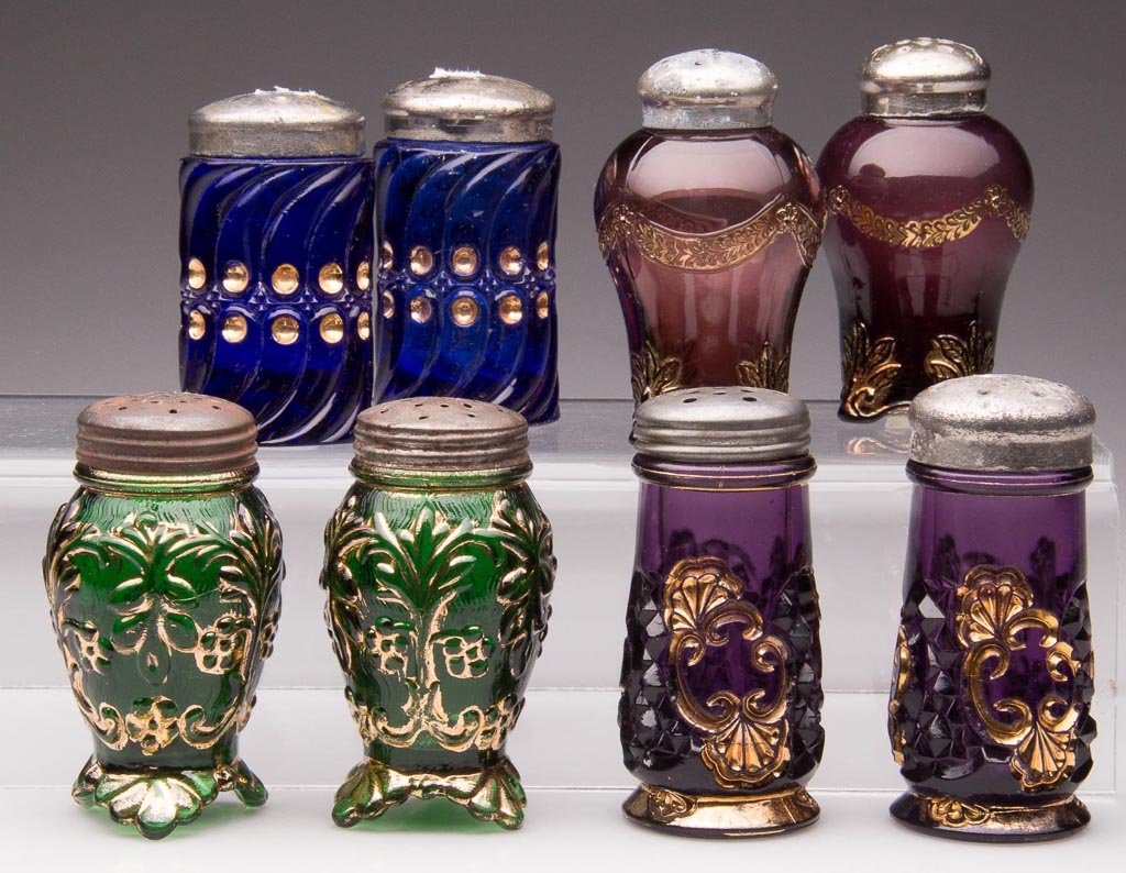 ASSORTED EAPG SALT AND PEPPER SHAKERS, LOT OF EIGHT: ASSORTED EAPG SALT AND PEPPER SHAKERS, LOT OF EIGHT, comprising pairs of amethyst Croesus, blue King's 500, amethyst Swag with Brackets, and green Flora, each with gilt decoration, period lids. Late 1