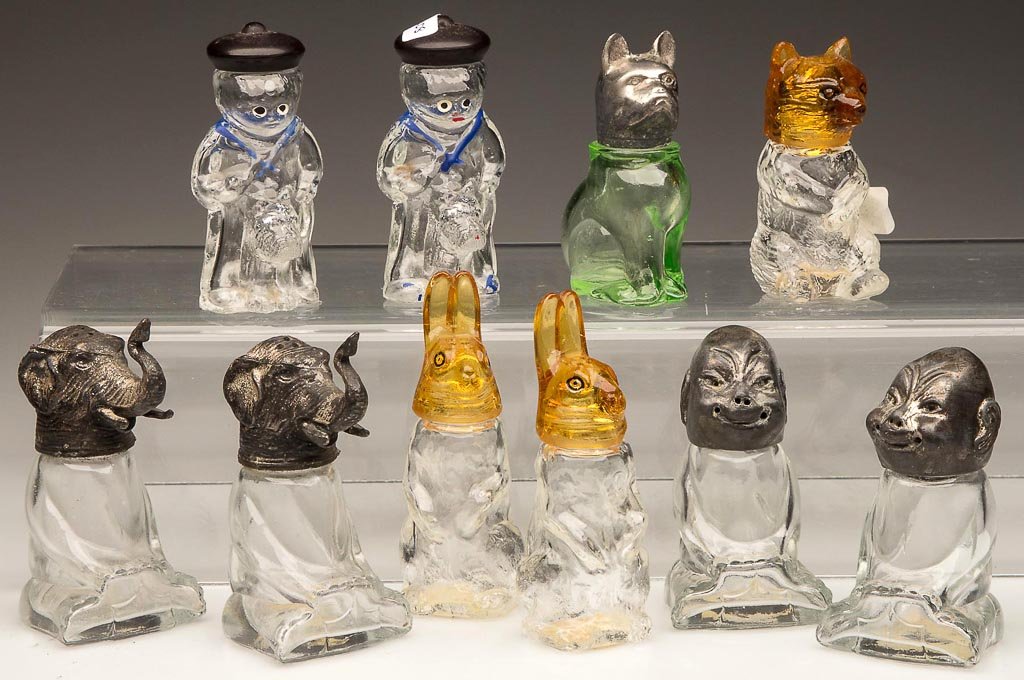 ASSORTED FIGURAL SALT AND PEPPER SHAKERS, LOT OF TEN: ASSORTED FIGURAL SALT AND PEPPER SHAKERS, LOT OF TEN, green, amber and colorless, including a pair of Startled Rabbit and Buster Brown and Tige, original metal, glass and plastic lids. First half 20th
