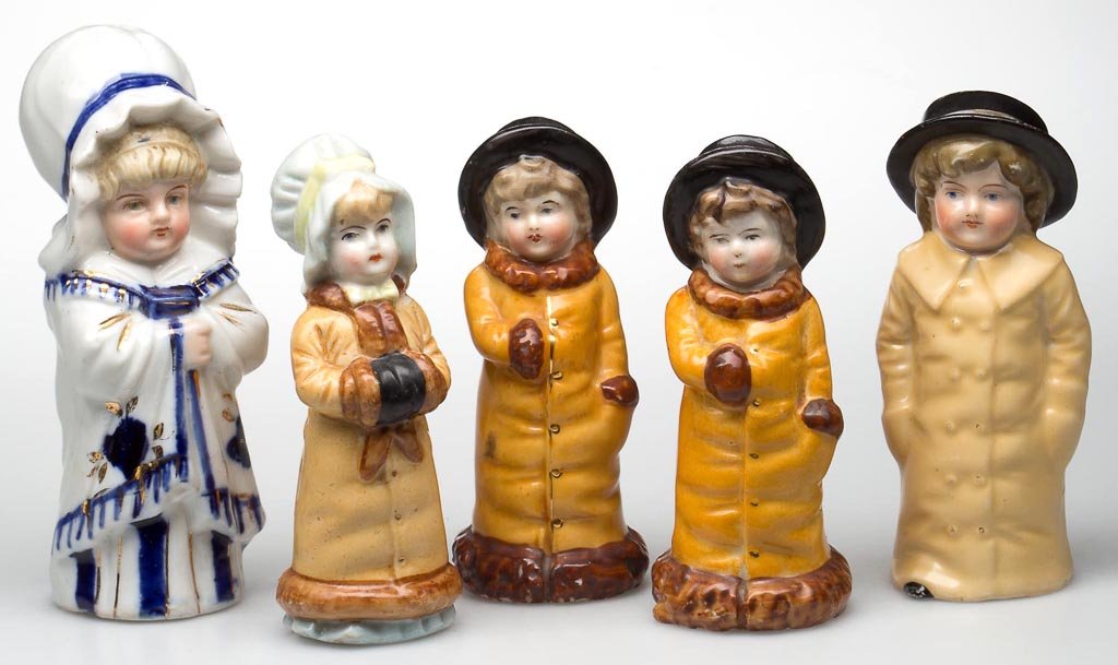 CHILDREN FIGURAL CERAMIC SALT AND PEPPER SHAKERS, LOT O: CHILDREN FIGURAL CERAMIC SALT AND PEPPER SHAKERS, LOT OF FIVE, Kate Greenaway style, each with corked base. Probably Germany. Fourth quarter 19th century. 4" to 4 3/4" HOA. Provenance: The collection 