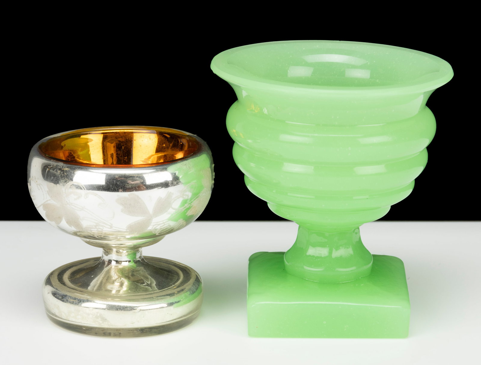 ASSORTED GLASS OPEN SALTS, LOT OF TWO: ASSORTED GLASS OPEN SALTS, LOT OF TWO, comprising a Mercury/Silvered glass example with hemispherical bowl, engraved decoration, and golden interior; and a pale green/opaline (reacts under black 