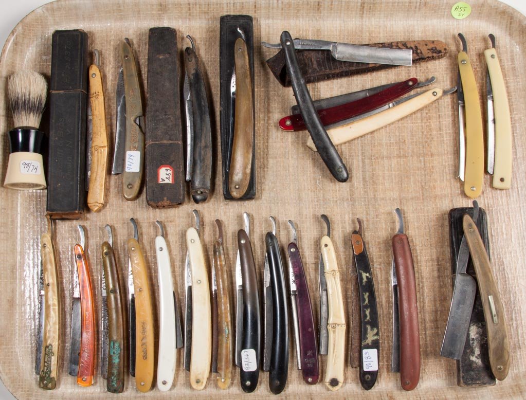 ASSORTED STRAIGHT RAZORS, LOT OF 23: ASSORTED STRAIGHT RAZORS, LOT OF 23, German, Sheffield and American makers, two with Columbian Exposition on blade. Together with a shaving brush. Twenty-four (24) pieces total. Late 19th/first quarte