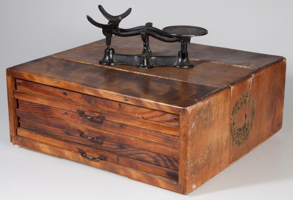 COUNTRY STORE SPOOL CABINET: COUNTRY STORE SPOOL CABINET, three drawers, partial Clark's ONT decals. Together with a cast-iron counter scales lacking pan. First half 20th century. 17 1/2" x 19 1/2".
