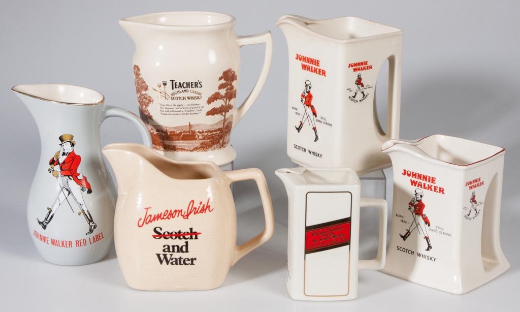 ASSORTED WHISKEY CERAMIC ADVERTISING PITCHERS, LOT OF: ASSORTED WHISKEY CERAMIC ADVERTISING PITCHERS, LOT OF SIX, comprising four Johnny Walker, Jameson and Teacher's. 20th century. 4 3/4" to 7 1/2" HOA. Provenance: From a Connecticut private collection.