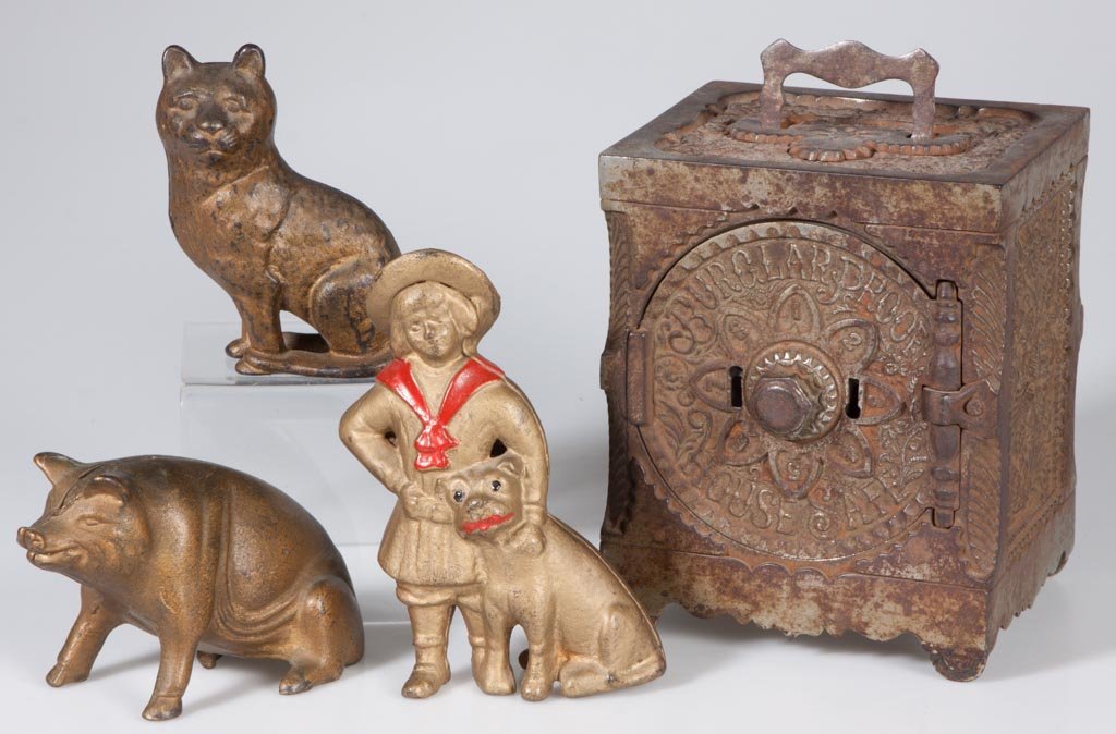 ASSORTED FIGURAL CAST-IRON PENNY BANKS, LOT OF FOUR: ASSORTED FIGURAL CAST-IRON PENNY BANKS, LOT OF FOUR, including Buster Brown and Tige and a "Key Combination Safe No. 40", original surfaces. A. C. Williams and J. & E. Stevens Co. Late 19th/first quar