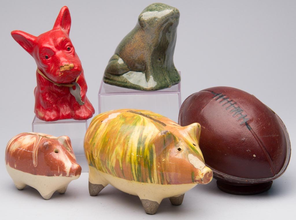 ASSORTED FIGURAL PENNY BANKS, LOT OF FIVE: ASSORTED FIGURAL PENNY BANKS, LOT OF FIVE, including two ceramic pig examples and a leather football form. 20th century. 2 3/4" to 5 1/4" HOA. Provenance: From the collection of the late Betty Jane Re