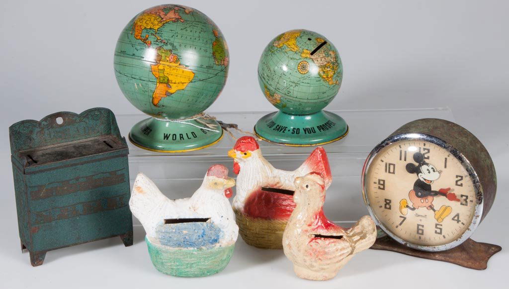 MICKEY MOUSE ALARM CLOCK AND SIX ASSORTED PENNY BANKS: MICKEY MOUSE ALARM CLOCK AND SIX ASSORTED PENNY BANKS, comprising tin and painted earthenware examples, clock by Ingersoll. First half 20th century. 3 1/2" to 4 1/2" H. Provenance: The estate collecti