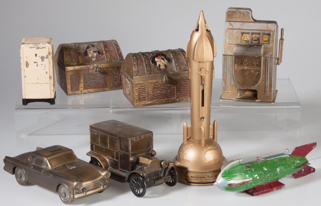 ASSORTED FIGURAL METAL PENNY BANKS, LOT OF EIGHT: ASSORTED FIGURAL METAL PENNY BANKS, LOT OF EIGHT, including "Mercury Rocket Bank" and "The Satellite Bank" mechanical examples. 20th century. 2" to 10 1/2" H. Provenance: From the collection of the la