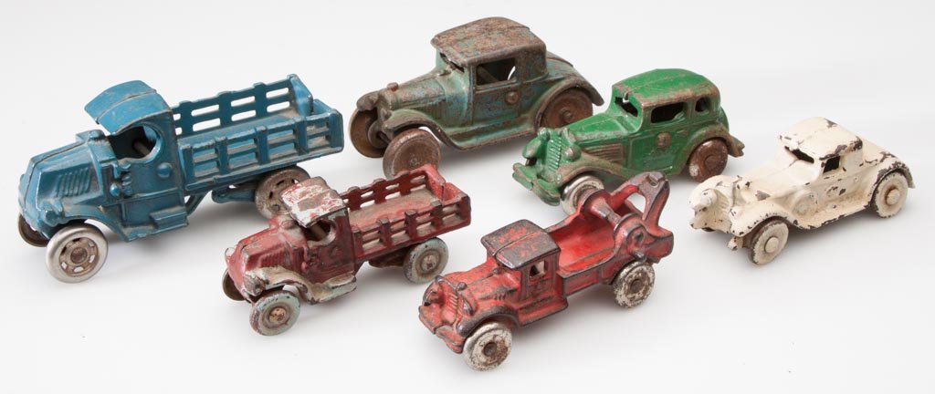 ASSORTED CAST-IRON TOY CARS AND TRUCKS, LOT OF SIX: ASSORTED CAST-IRON TOY CARS AND TRUCKS, LOT OF SIX, including Arcade, each with metal wheels, four with original paint. First half 20th century. 3 1/2" to 4 3/4" L. Provenance: The Elizabeth P. Croft 