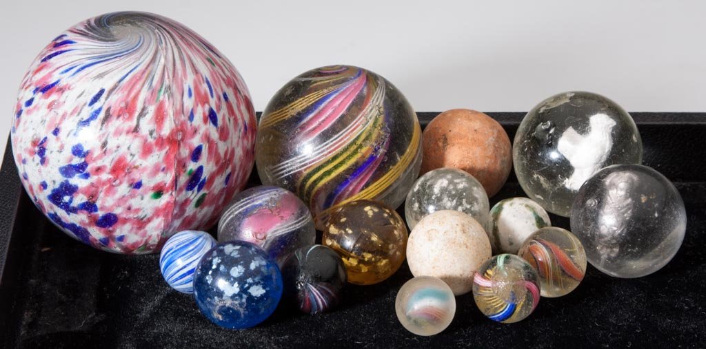 ASSORTED HAND-MADE MARBLES, LOT OF 16: ASSORTED HAND-MADE MARBLES, LOT OF 16, including onionskin, Indian swirl, other swirls, Papoose and Rooster sulphides, mica and clay. Late 19th/early 20th century. 1/2" to 2 3/8" D. Provenance: The El