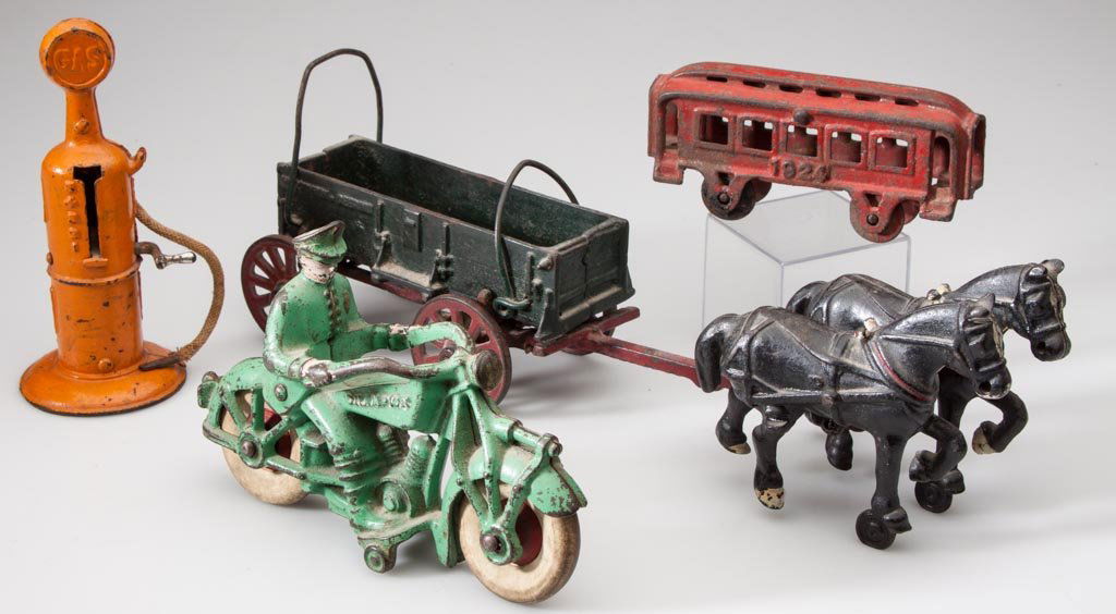 ASSORTED CAST-IRON TOYS, LOT OF FOUR: ASSORTED CAST-IRON TOYS, LOT OF FOUR, including a Champion Police Motorcycle, an Arcade horse-drawn wagon, and a gas pump, original paint. First half 20th century. 5 1/2" to 14" L. Provenance: The Eli