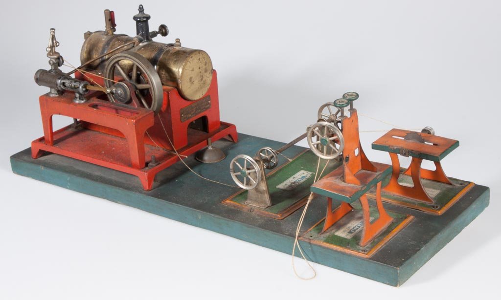 WEEDEN STEAM ENGINE SET: WEEDEN STEAM ENGINE SET, comprising a No. 648 engine and three tools, all mounted on a wooden board. First half 20th century. Engine 6 1/2" H, board 7 3/4" x 21". Provenance: The estate collection of 