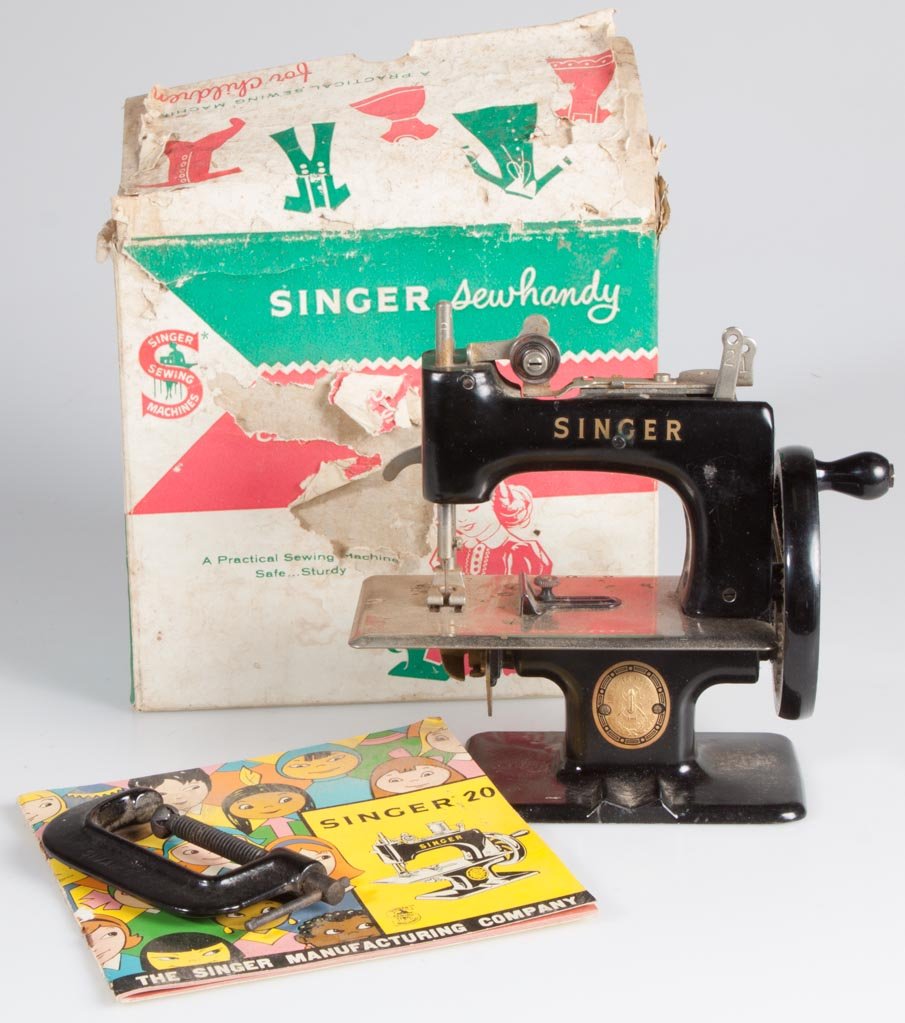 SINGER NO. 20 SEWHANDY CHILD'S SEWING MACHINE: SINGER NO. 20 SEWHANDY CHILD'S SEWING MACHINE, with clamp, booklet and partial box. Mid 20th century. 6 1/2" H. Provenance: From an Illinois private collection.