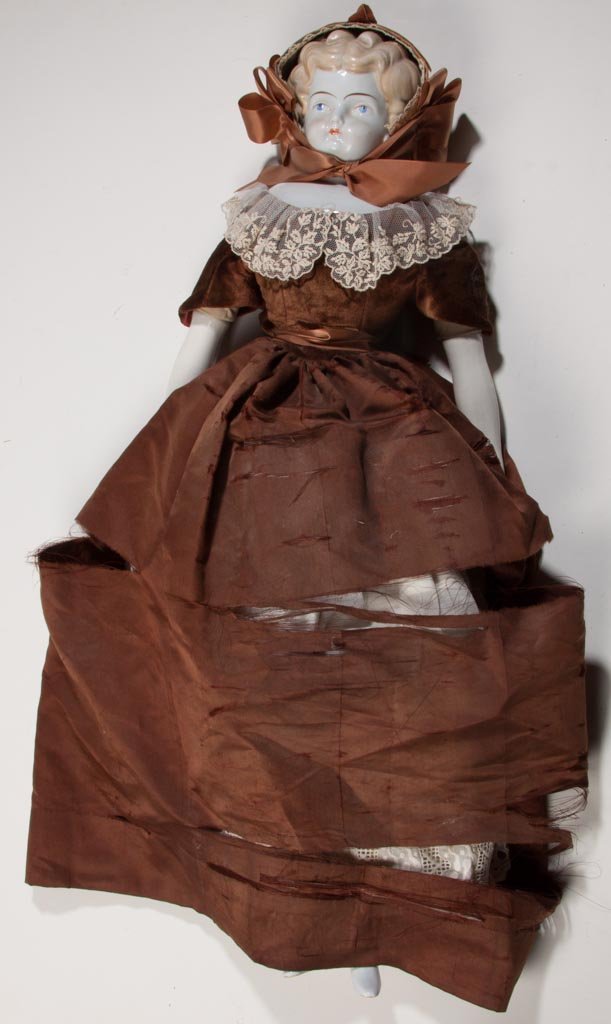 LARGE GERMAN CHINA-HEAD DOLL: LARGE GERMAN CHINA-HEAD DOLL, shoulder head with blonde 1860-1870 flat-top/Civil War hairstyle, high brow, painted on eyes and brows, cloth body, china arms and legs. Vintage clothing, possibly origin