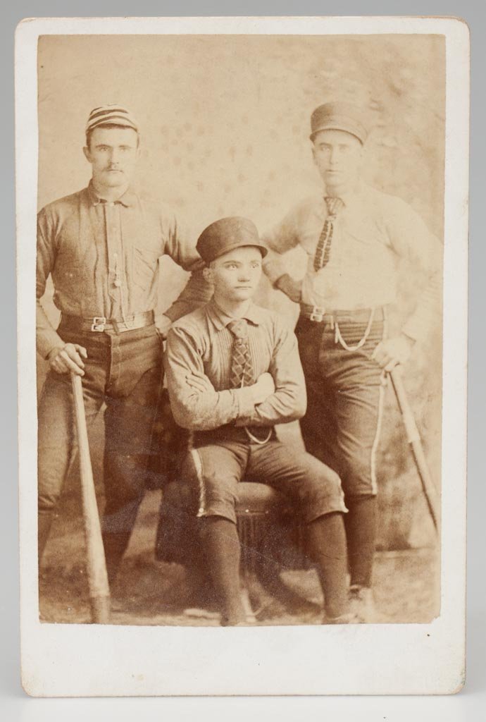 EARLY BASEBALL CABINET PHOTO: EARLY BASEBALL CABINET PHOTO, albumen print on card stock with blank back, depicting three players in dress uniforms, two with bats, no identification or photographer's stamp. Fourth quarter 19th cent