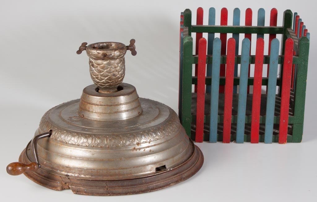 VINTAGE CHRISTMAS TREE STANDS, LOT OF TWO: VINTAGE CHRISTMAS TREE STANDS, LOT OF TWO, comprising a Swiss musical rotating stand and a painted wooden-picket style stand surround. Late 19th/first quarter 20th century. 8 1/2" H, surround 10" SQ. 