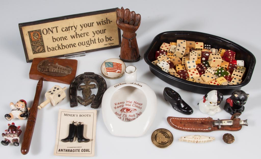 ASSORTED VINTAGE COLLECTIBLES: ASSORTED VINTAGE COLLECTIBLES, uncounted lot, including a silver-mounted carved rosewood hand, an American flag horse bridle rosette converted into a brooch, and a collection of dice. 20th century. Ha