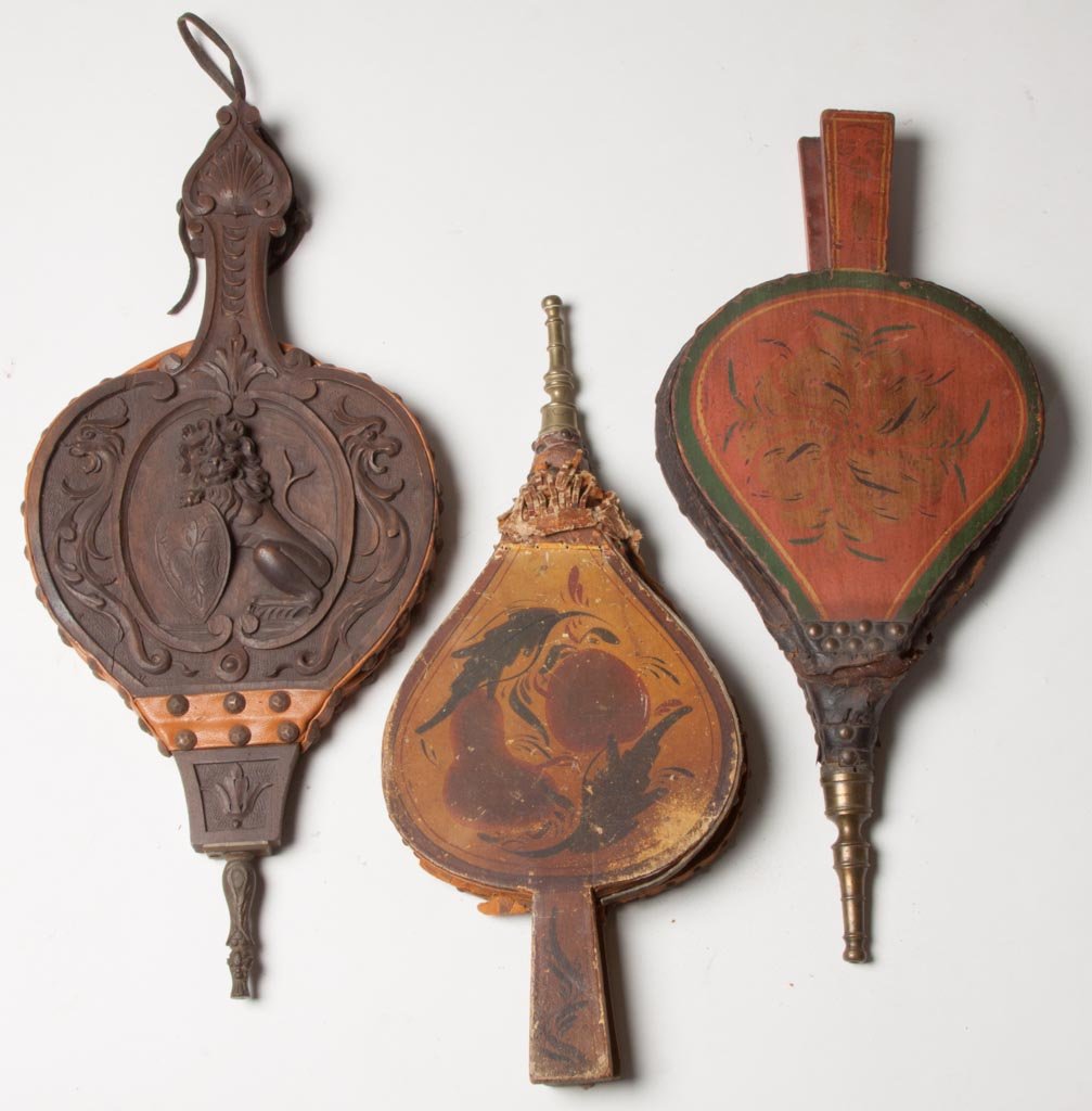 WOOD AND BRASS FIREPLACE BELLOWS, LOT OF THREE: WOOD AND BRASS FIREPLACE BELLOWS, LOT OF THREE, comprising two with original painted decoration, and one with carved British Lion. First quarters of the 19th and 20th centuries. 16 1/2" to 19" L. Prov