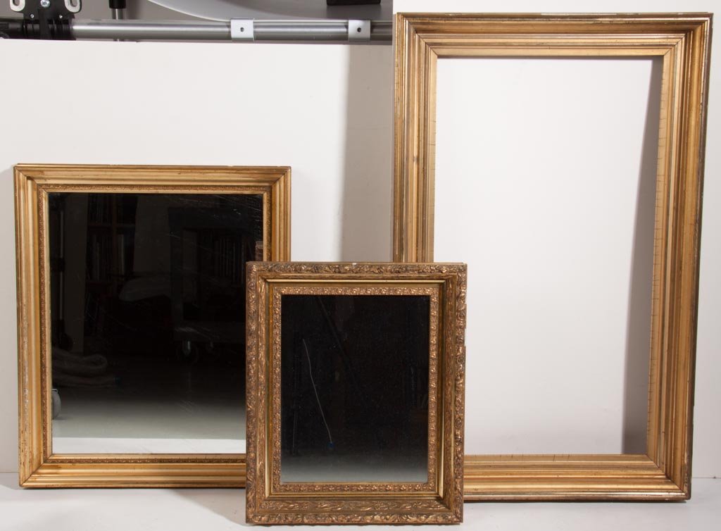 VICTORIAN GILDED PICTURE FRAMES, LOT OF THREE: VICTORIAN GILDED PICTURE FRAMES, LOT OF THREE, one with gesso ornamentations, two fitted with mirrors. Second half 19th century. Smallest 18" x 15" overall. Provenance: The estate collection of Richar