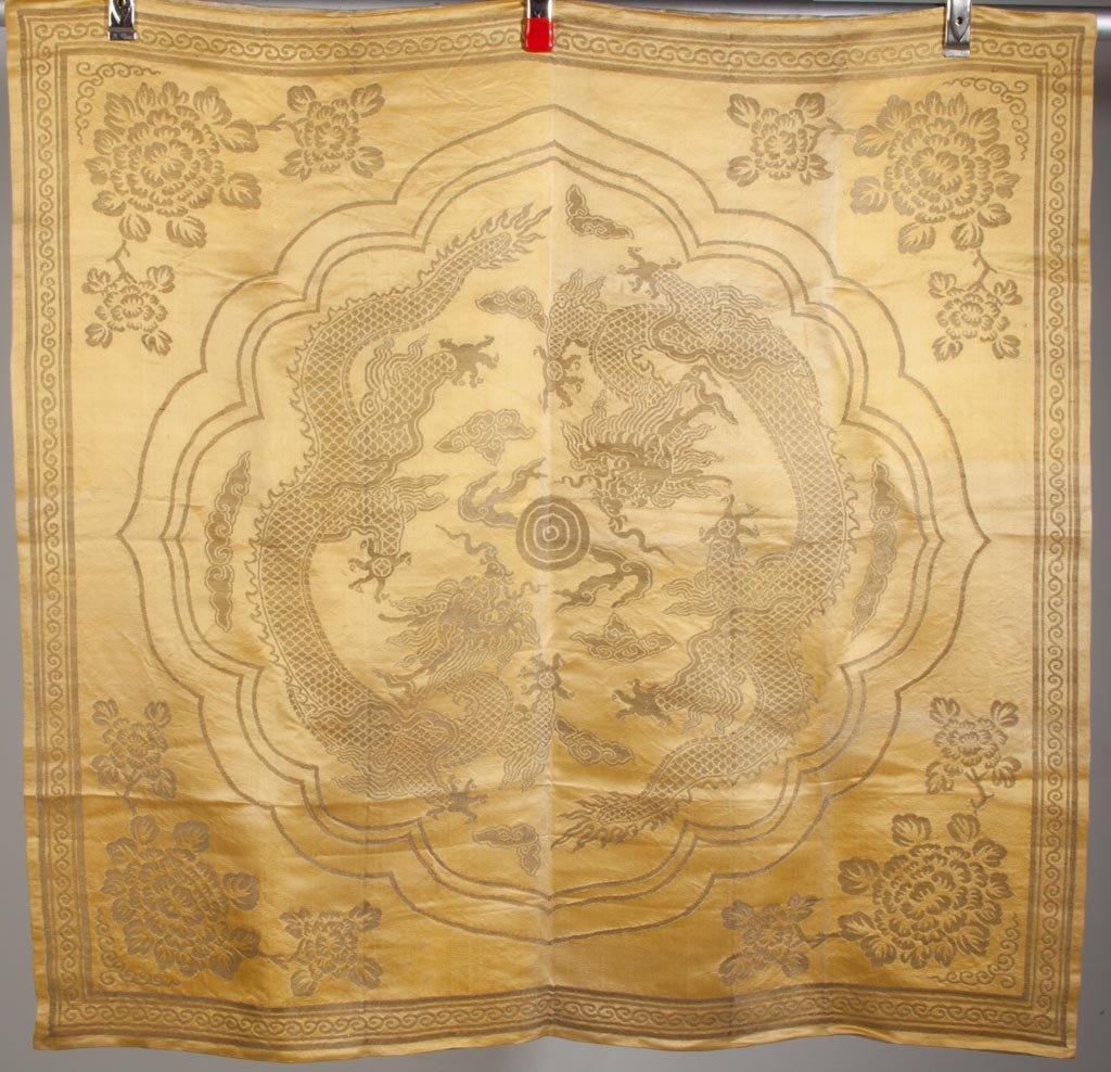 CHINESE EMBROIDERED YELLOW SILK ALTAR CLOTH: CHINESE EMBROIDERED YELLOW SILK ALTAR CLOTH, metallic silver embroidery depicting a five-toed dragon and chrysanthemums, joined three panel backing with markings in two corners. Late 19th/early 20th c