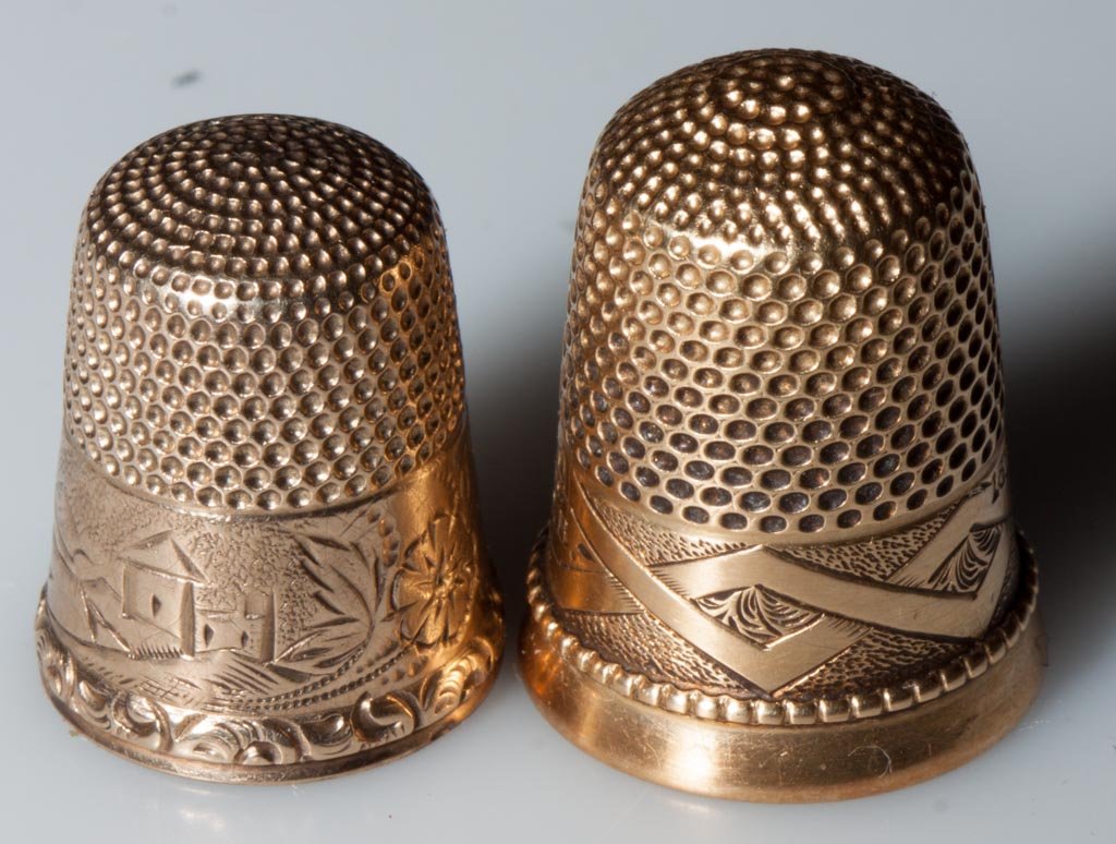 VICTORIAN GOLD THIMBLES, LOT OF TWO: VICTORIAN GOLD THIMBLES, LOT OF TWO, comprising a marked 18K example with an engraved and beaded base, dated 1866, and a tested 10K example with engraved floral base marked for Simon Brothers. Total w