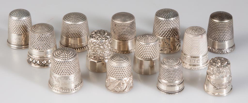 VINTAGE SILVER THIMBLES, LOT OF 13: VINTAGE SILVER THIMBLES, LOT OF 13, most marked Sterling, one embossed with alligator and "FLORIDA", various ornamentations. Total weight: 1.875 ozt. Late 19th/first half 20th century. 3/4" to 7/8" H.