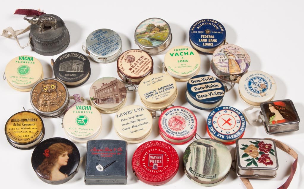 ASSORTED ADVERTISING AND NOVELTY TAPE MEASURES, LOT OF : ASSORTED ADVERTISING AND NOVELTY TAPE MEASURES, LOT OF 25, celluloid and metal. 20th century. 1 3/8" to 1 3/4" D. Provenance: From an Illinois private collection. Circa:20th century.