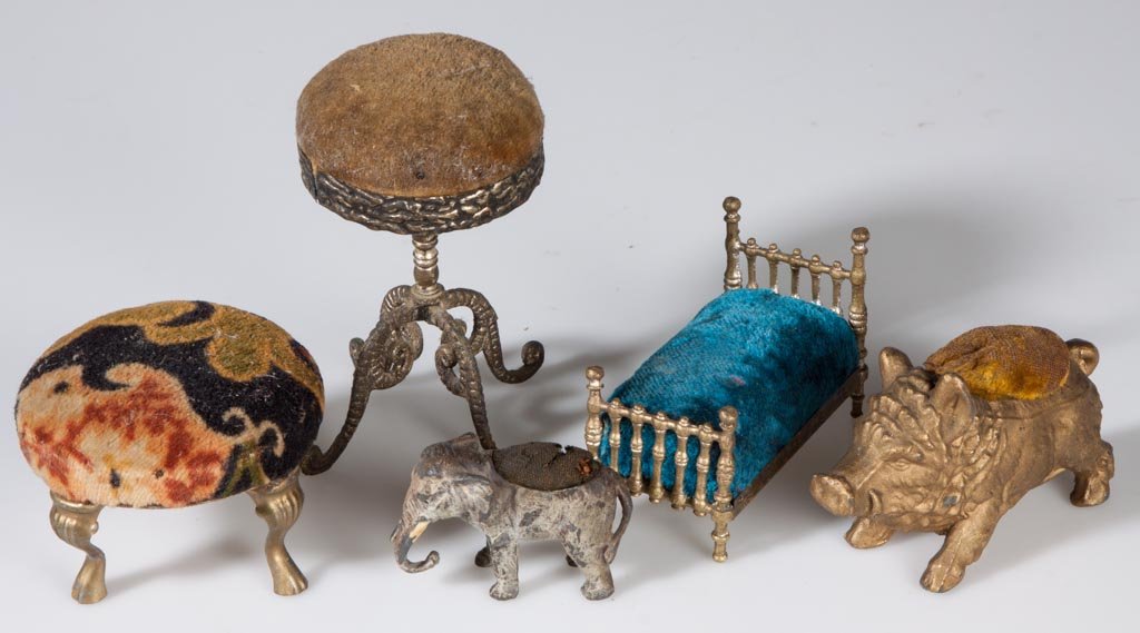 ASSORTED METAL FIGURAL PIN CUSHIONS, LOT OF FIVE: ASSORTED METAL FIGURAL PIN CUSHIONS, LOT OF FIVE, comprising a wild boar, an elephant, two stools and a bed. Late 19th/early 20th century. 1 1/2" to 4" H. Provenance: From an Illinois private collecti