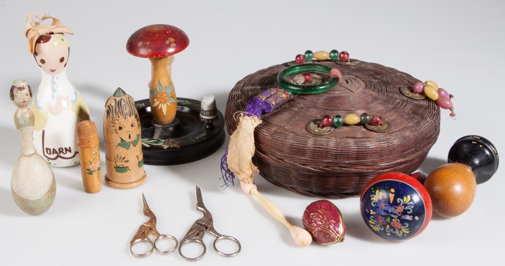 ASSORTED VINTAGE SEWING ACCOUTREMENTS, LOT OF 12: ASSORTED VINTAGE SEWING ACCOUTREMENTS, LOT OF 12, including wooden and ceramic darners and figural scissors. First half 20th century. Basket 7 1/2" D. Provenance: From an Illinois private collection. 
