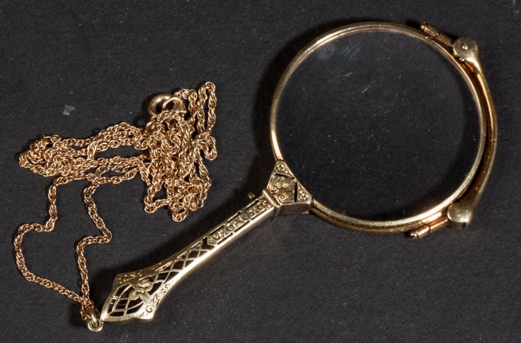 LADY'S 14K YELLOW GOLD LORGNETTE: LADY'S 14K YELLOW GOLD LORGNETTE, folds and locks into the filigree handle, marked, with a gold-filled chain. First quarter 20th century. 5" L open. Provenance: The estate collection of Richard and Be