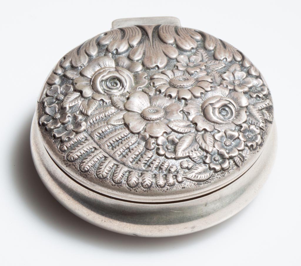 TIFFANY STERLING SILVER BOX: TIFFANY STERLING SILVER BOX, hinged cover with repousse floral ornamentation, monogrammed under base. Weight: 1.69 ozt. 20th century. 2 1/4" D. Provenance: The estate collection of Richard and Betty R